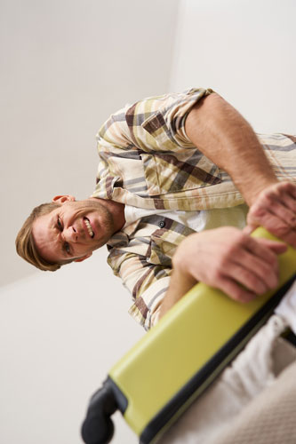 person packing luggage with a lot of force