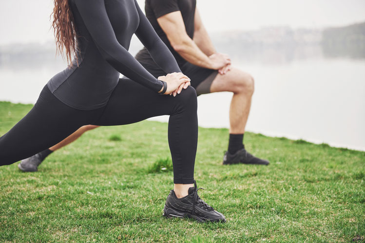 couple exercising outside for burning some fat